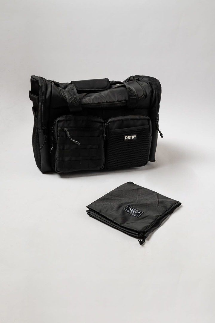 DBTK Black Duffle Bag (Category: Sling Bags) located in Quezon City. Submitted by godspeed___ (Listing ID 1466141616, Image 2). Description: - Brand: DBTK (Don't Blame The Kids) - Color: Black - Durable heavy-duty straps and rugged zippers - Multiple external compartments and mesh pockets - Tactical-style webbing loops on the front pocket - Includes a matching drawstring pouch with logo patch - Versatile use: ideal for everyday carry or the gym D