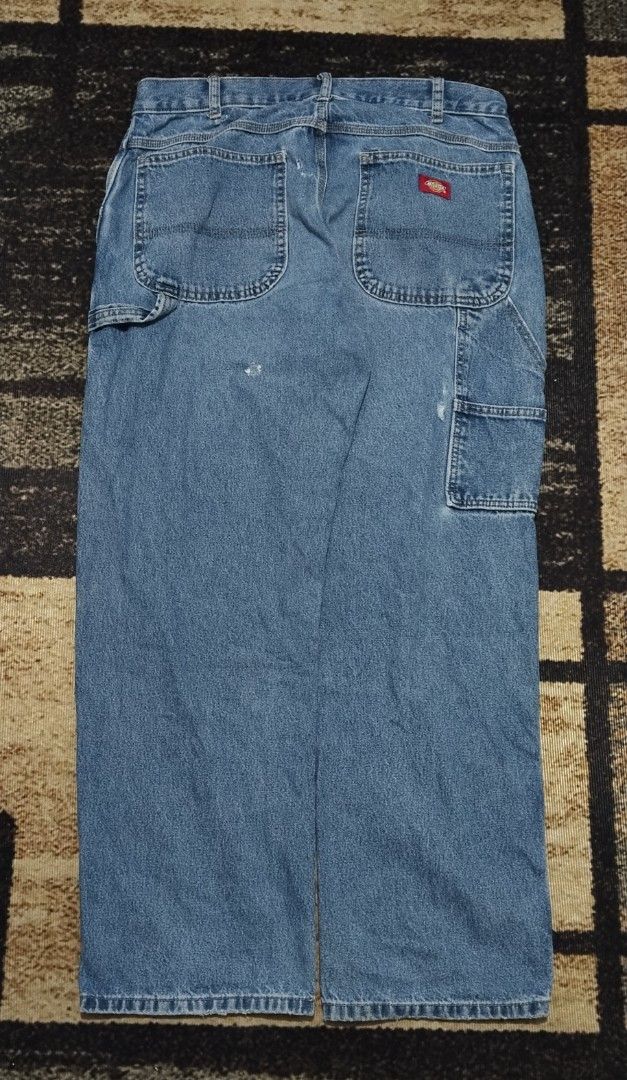 Dickies Light Wash Denim Carpenter Jeans (Category: Jeans) located in Manila. Submitted by ianmontede19006 (Listing ID 1466010667, Image 3). Description: - Brand: Dickies - Style: Denim carpenter jeans with utility pockets and side hammer loops - Color/Wash: Light blue - Fit: Relaxed fit through the leg - Details: Branded metal button closure, iconic red Dickies logo patch on back pocket - Condition: Excellent vintage workwear aesthetic.