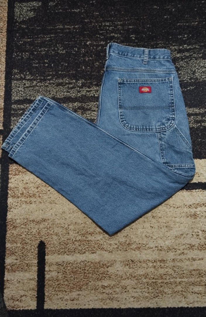 Dickies Light Wash Denim Carpenter Jeans (Category: Jeans) located in Manila. Submitted by ianmontede19006 (Listing ID 1466010667, Image 1). Description: - Brand: Dickies - Style: Denim carpenter jeans with utility pockets and side hammer loops - Color/Wash: Light blue - Fit: Relaxed fit through the leg - Details: Branded metal button closure, iconic red Dickies logo patch on back pocket - Condition: Excellent vintage workwear aesthetic.