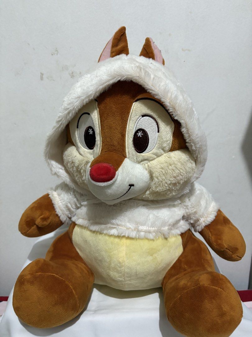 Disney Dale winter plush toy (Category: Plushies & Soft Toys) located in Binan City. Submitted by treasurejoycollection (Listing ID 1466125072, Image 1). Description: - Character: Chip or Dale plush toy in a sitting position - Outfit: White fluffy hoodie with adorable snowflake details in the eyes - Features: Soft brown and yellow fur with a cute red nose - Condition: Clean fabric, well-maintained, and collector-ready - Perfect for gifts or addin