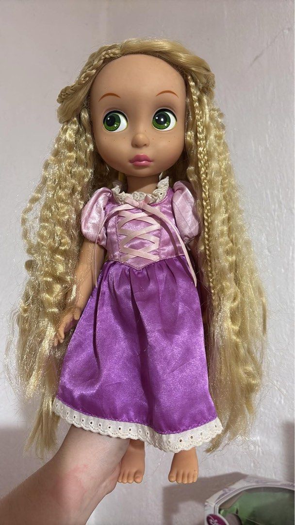 Disney Princess Rapunzel Animator (Category: Kids Toys) located in La Trinidad. Submitted by caicai1926 (Listing ID 1466035751, Image 1). Description: - Authentic Disney Rapunzel toddler doll - Beautiful long blonde crimped hair with braided details (full and fluffy) - Expressive big green eyes and cute freckles - Wears signature purple satin dress with pink lace-up bodice and white lace trim - Barefoot design .