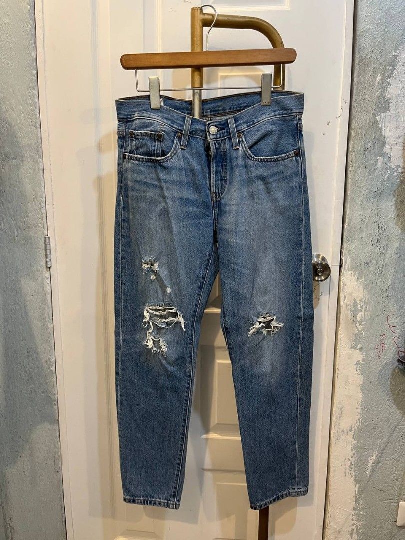 distressed Jeans (Category: Jeans) located in Quezon City. Submitted by chicberry (Listing ID 1466119875, Image 1). Description: Levi's 501 distressed denim jeans in a classic light blue wash. Button fly closure, traditional five-pocket styling, and signature leather patch on the back waistband. Pre-loved with factory-style distressing and fading at the knees and pockets. Straight leg cut. No size stated on the leather patch..