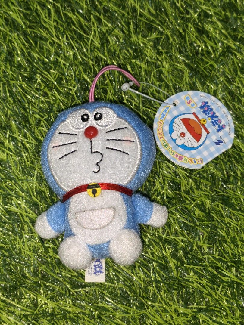 Doraemon Plush Mascot Strap with Tag (Category: Plushies & Soft Toys) located in Paranaque City. Submitted by furugiyafinds (Listing ID 1466109610, Image 1). Description: - Authentic Doraemon plush keychain with original paper tag - Features an adorable whistling expression with pink blush marks - Made with soft, fuzzy material in classic blue and white - Equipped with a convenient pink strap string at the top - Clean tag with Japanese text intac