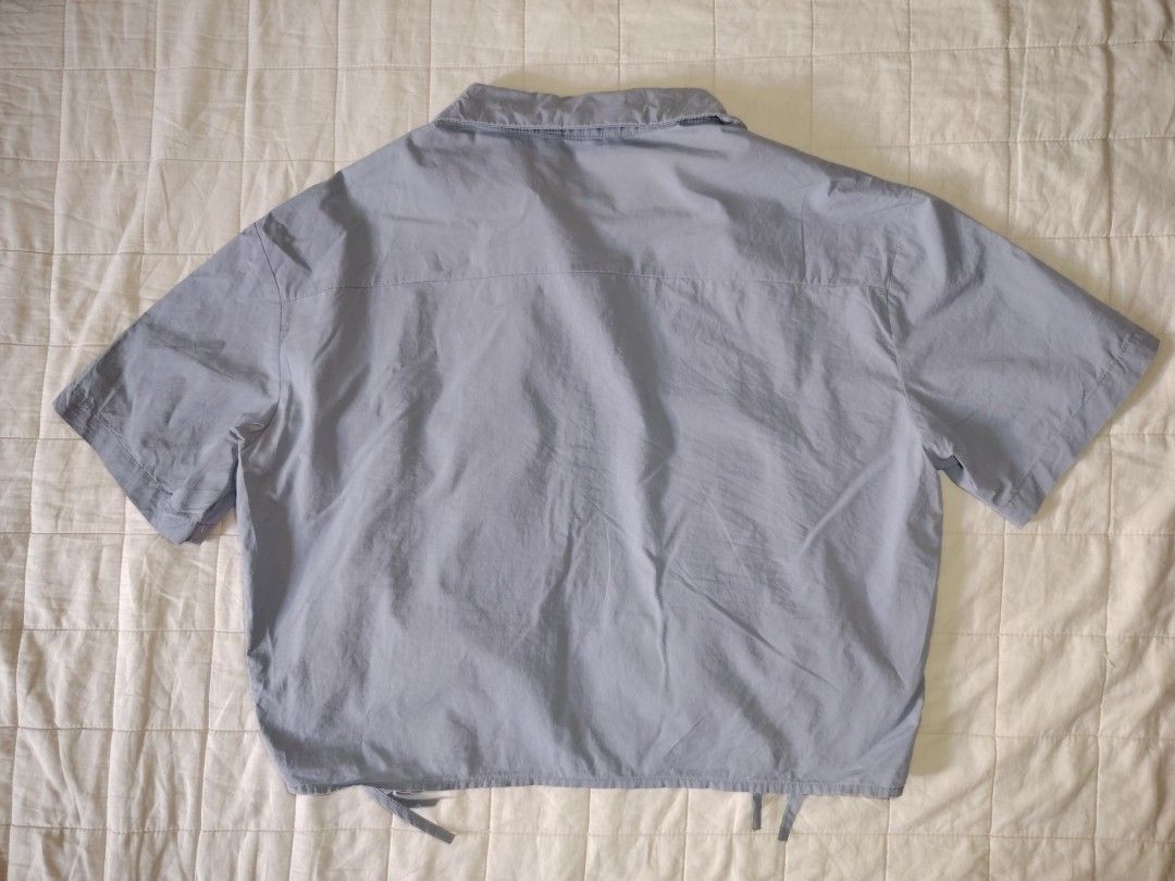 Dust Blue Ruched Drawstring Short Sleeve Button-Down Crop Shirt (Category: Blouses) located in Tarlac. Submitted by your_finds (Listing ID 1466008946, Image 3). Description: Description: - Large ang size - Dusty blue ang color - Cropped collared button-down shirt - Adjustable front drawstrings Condition: 9/10 / Very good condition Medida size (inch) Bust: 40 Length: 18.
