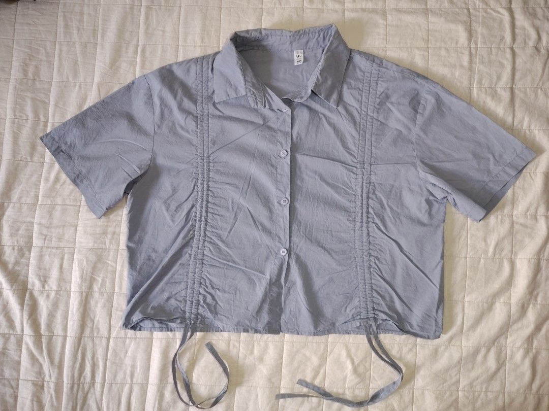 Dust Blue Ruched Drawstring Short Sleeve Button-Down Crop Shirt (Category: Blouses) located in Tarlac. Submitted by your_finds (Listing ID 1466008946, Image 2). Description: Description: - Large ang size - Dusty blue ang color - Cropped collared button-down shirt - Adjustable front drawstrings Condition: 9/10 / Very good condition Medida size (inch) Bust: 40 Length: 18.