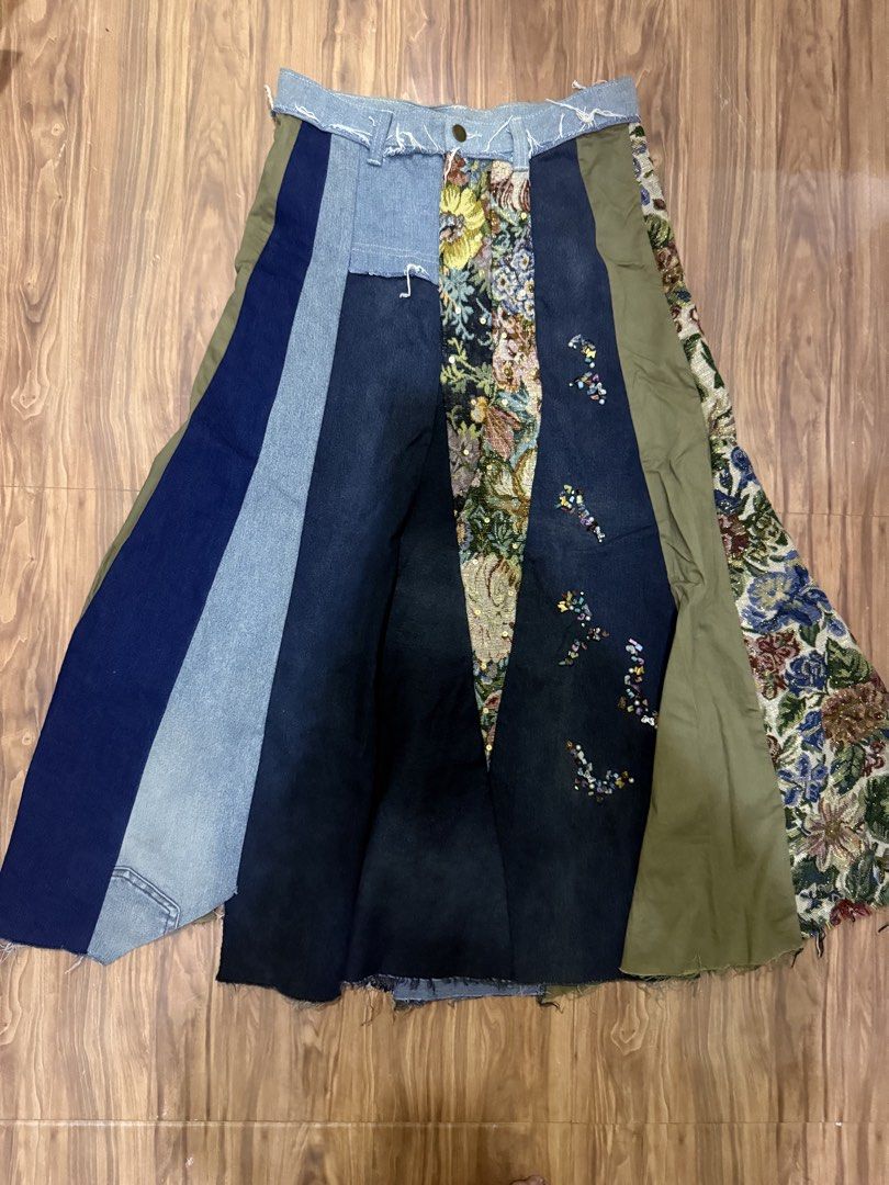 E+ Patchwork Denim and Tapestry Maxi Skirt (Category: Skirts) located in Cebu City. Submitted by hotchkisscebu (Listing ID 1466103501, Image 1). Description: - Brand/Size: E+, Size L - Material: Mixed denim washes, olive green fabric, and ornate floral tapestry panels - Details: Colourful beaded clusters and butterfly charms along a dark denim stripe - Finish: Raw frayed hem at the waistline - Closure: Front button closure - Style: Eye-catching e