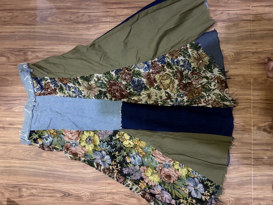 E+ Patchwork Denim and Tapestry Maxi Skirt (Category: Skirts) located in Cebu City. Submitted by hotchkisscebu (Listing ID 1466103501, Image 2). Description: - Brand/Size: E+, Size L - Material: Mixed denim washes, olive green fabric, and ornate floral tapestry panels - Details: Colourful beaded clusters and butterfly charms along a dark denim stripe - Finish: Raw frayed hem at the waistline - Closure: Front button closure - Style: Eye-catching e