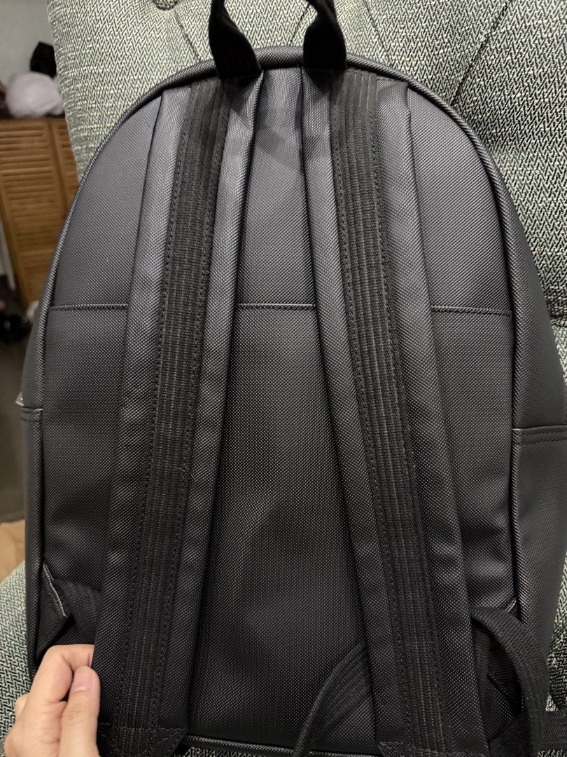 Elegant Unisex Lacoste Black Backpack (Category: Backpacks) located in Quezon City. Submitted by skoom (Listing ID 1466101559, Image 2). Description: - Classic Elegant Black - Spacious main compartment with laptop compartment and small pockets inside + front zippered pocket with outer slip slots + open back pocket - Silver-toned with Lacoste crocodile logo stamps on strap adjusters and lower front - Adjustable shoulder straps - Clean stitching an