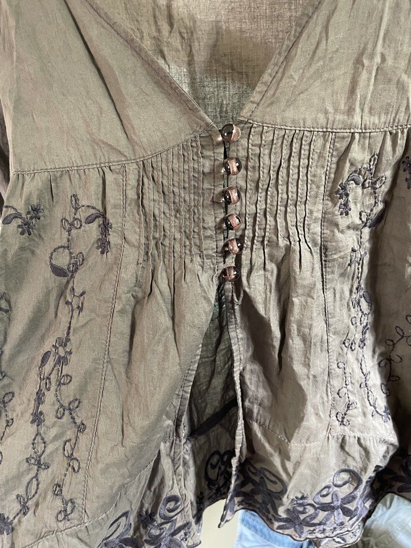 embroidered long sleeve V-neck blouse (Category: Longsleeves) located in Baybay. Submitted by shikita27906 (Listing ID 1466036508, Image 3). Description: - Color: Olive green - Style: Long sleeve blouse with deep V-neckline - Details: Dark floral embroidery, small button placket, and pleated details below the chest - Fit: Relaxed fit, lightweight material - Can fit M-L.