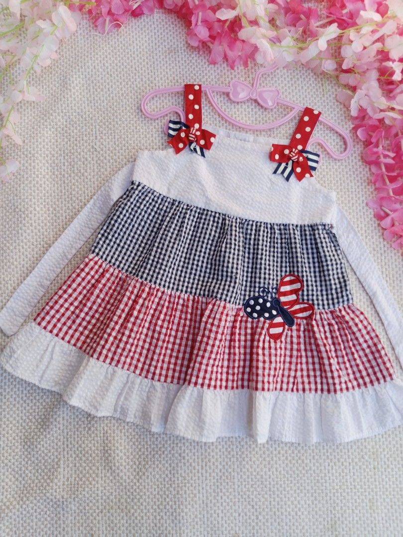 Emily Rose Butterfly Dress (Category: Babies & Kids Fashion) located in Sipocot. Submitted by mszari (Listing ID 1466001538, Image 2). Description: Emily Rose Patriotic Butterfly Tiered Dress (Size 18M) Price: ₱480 (Open for OFFER) Description: 🦋 Classic Preppy Gingham Dress 🦋 • Brand: Emily Rose • Size: Infant 18 Months • Color: Navy Blue, Red, and White • Design: Multi-pattern look featuring polka-dot shoulder bows, a seersucker bodice, stack