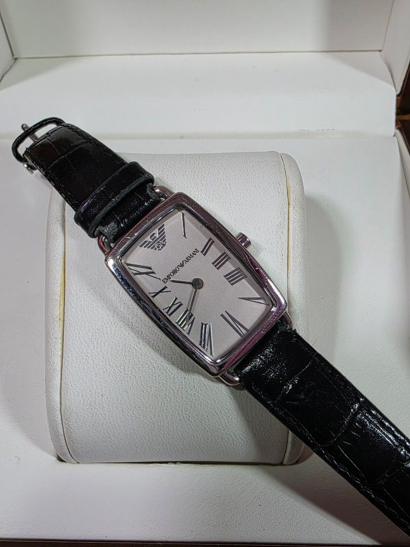 Emporio Armani AR-2107 Rectangular Watch (Category: Men's Watches) located in Rosales. Submitted by akumie30 (Listing ID 1466110679, Image 2). Description: Emporio Armani AR-2107 wrist watch. Rectangular silver dial, black leather strap. Roman numeral markers, Emporio Armani logo on the face. Solid stainless steel case back, 50 meters water resistant. Crown stamped with the Armani logo. Standard buckle closure. Original Armani Watch Working Condi