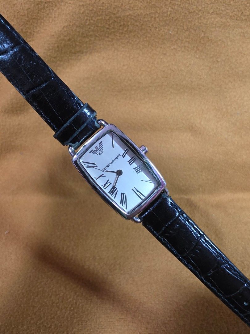 Emporio Armani AR-2107 Rectangular Watch (Category: Men's Watches) located in Rosales. Submitted by akumie30 (Listing ID 1466110679, Image 3). Description: Emporio Armani AR-2107 wrist watch. Rectangular silver dial, black leather strap. Roman numeral markers, Emporio Armani logo on the face. Solid stainless steel case back, 50 meters water resistant. Crown stamped with the Armani logo. Standard buckle closure. Original Armani Watch Working Condi