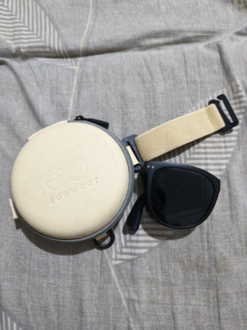 EO Sunwear Polarized Sunglasses with Hard Case (Category: Sunglasses & Eyewear) located in Manila. Submitted by rafaellyns62118 (Listing ID 1466096808, Image 3). Description: For sale E.O foldable polarized sunglasses - Brand: EO Sunwear / brandnew - Frame: Classic black with foldable temple arms - Lenses: Dark tinted polarized lenses for glare reduction - Inclusion: Cream-colored round hard case with zipper and strap - Packaging: Includes origin