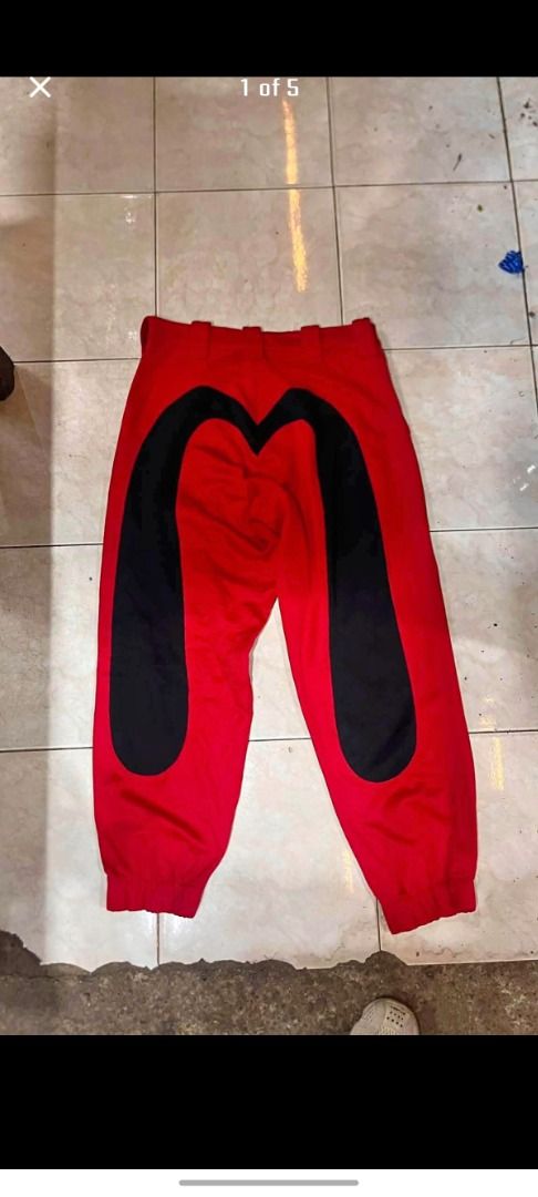 Evisu Red and Black Graphic Pants (Category: Jeans) located in Caloocan City. Submitted by silverbird_6c038f (Listing ID 1466042996, Image 1). Description: - Brand: Evisu (Custom Made Heritage Line) - Color: Bold red with striking black leg branding - Size: S (170/76A) - Details: Branded metal button & interior chambray waistband - Condition: Bright colorway, clean construction, ready to wear - Style: Unique streetwear statement piece.