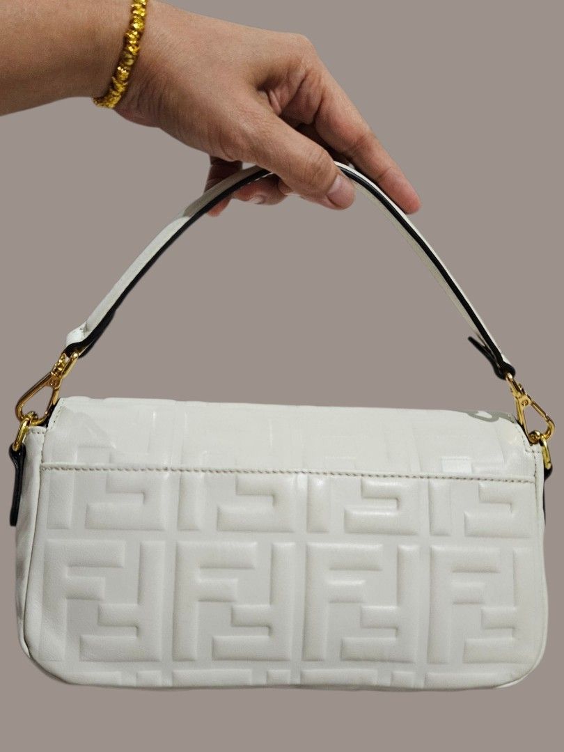 Fendi Embossed Baguette Bag (Category: Shoulder Bags) located in Caloocan City. Submitted by zoetormojal.18d615 (Listing ID 1466023331, Image 2). Description: Fendi White Embossed Leather Baguette Bag - Genuine nappa leather - Embossed FF logo pattern - Gold FF buckle closure - Genuine leather material - Single top handle - Chic and stylish design - Thrifted in Dubai - H 6" x L 10" x D 2.5" Inches - NO Issue all intact just like new condition - P