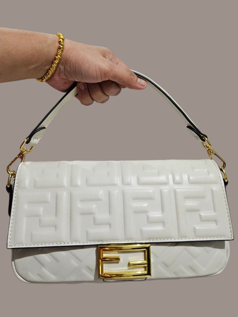 Fendi Embossed Baguette Bag (Category: Shoulder Bags) located in Caloocan City. Submitted by zoetormojal.18d615 (Listing ID 1466023331, Image 1). Description: Fendi White Embossed Leather Baguette Bag - Genuine nappa leather - Embossed FF logo pattern - Gold FF buckle closure - Genuine leather material - Single top handle - Chic and stylish design - Thrifted in Dubai - H 6" x L 10" x D 2.5" Inches - NO Issue all intact just like new condition - P