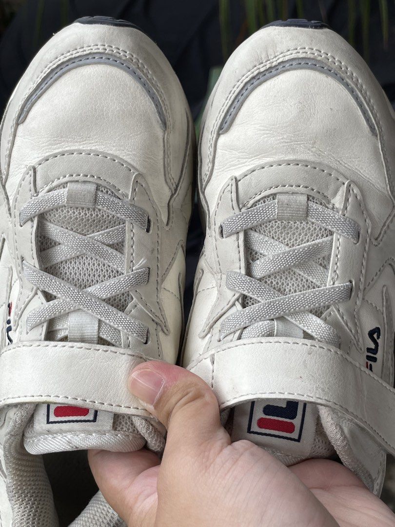 Fila White Sneakers Size US 2 / EU 33.5 (Category: Sneakers) located in Zamboanga. Submitted by stephoney03 (Listing ID 1466038026, Image 2). Description: - Brand: Fila Kids Sneakers - Color: White - Size: US 2 | EUR 33.5 | UK 1 | MM 210 - Closure: Velcro strap and lace-up front - Materials: Synthetic upper, textile lining, rubber outsole - Branding: Fila logo on side, tongue, heel, and sole - Condition: Pre-loved with visible scuff marks and dir