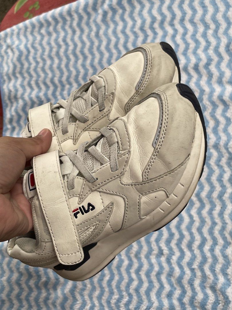 Fila White Sneakers Size US 2 / EU 33.5 (Category: Sneakers) located in Zamboanga. Submitted by stephoney03 (Listing ID 1466038026, Image 1). Description: - Brand: Fila Kids Sneakers - Color: White - Size: US 2 | EUR 33.5 | UK 1 | MM 210 - Closure: Velcro strap and lace-up front - Materials: Synthetic upper, textile lining, rubber outsole - Branding: Fila logo on side, tongue, heel, and sole - Condition: Pre-loved with visible scuff marks and dir