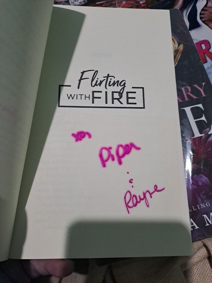 Flirting with Fire by Piper Rayne Paperback Novel (Category: Storybooks) located in Quezon City. Submitted by booksaremyimagination (Listing ID 1466044129, Image 2). Description: - Title: Flirting with Fire by Piper Rayne - Edition: Paperback with vibrant orange cover - Special Feature: Authentic author signature inside the front page in pink ink - Genre: Contemporary romance - Condition: Well-maintained, great for collectors and book lovers.