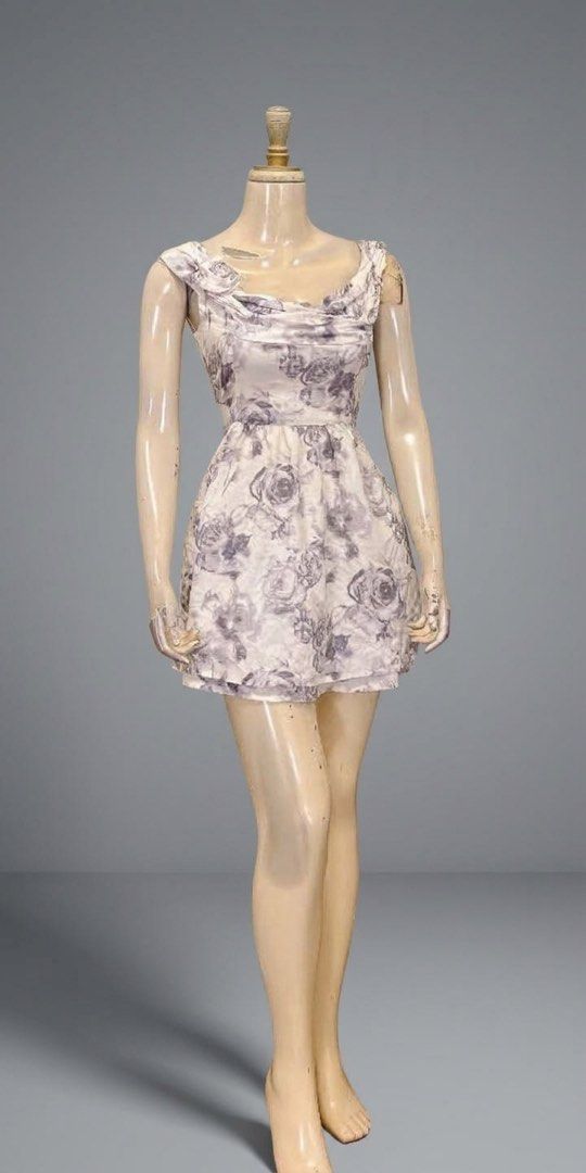 Floral pattern sleeveless mini dress (Category: Dresses) located in Quezon City. Submitted by bipolarbear2 (Listing ID 1466025816, Image 1). Description: - Style: Short sleeveless dress with a chic floral rose print - Color: Neutral grey and white palette - Neckline: Scoop neck with stylish draped fabric detail - Fit: Fitted waist leading to a flared skirt - Condition: Excellent / Like new - Perfect for: Casual outings, dates, or weekend brunch.