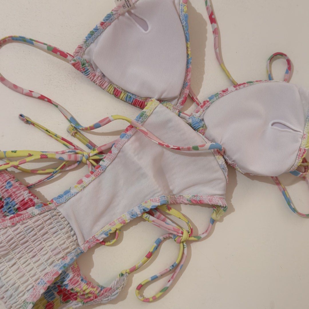 Floral Smocked Bikini Set (Category: Bikinis & Swimsuits) located in Cebu City. Submitted by softly.preloved (Listing ID 1466153353, Image 3). Description: - no issues. Used only twice -size: M (tag attached) but adjustable ties so it can fit small - colorful floral print (yellow, pink, blue) with a trendy smocked texture - top: triangle style with adjustable ties - bottoms: matching tie-side design with moderate coverage .