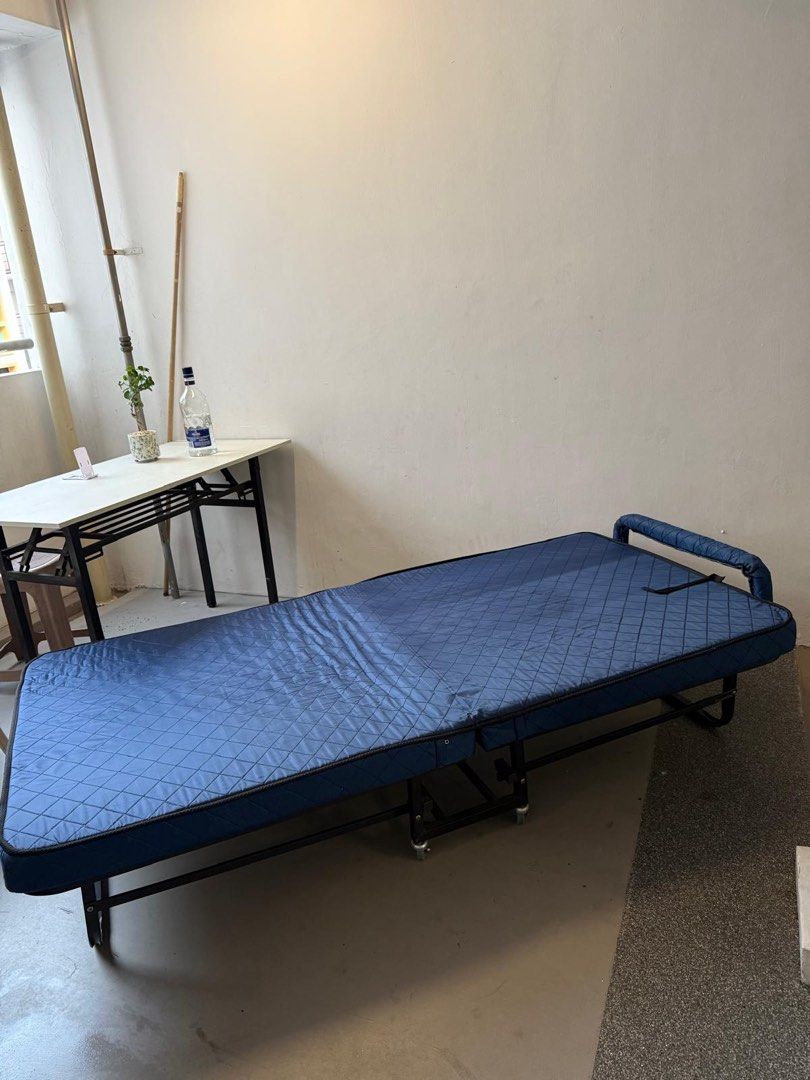 Foldable bed (Category: Bed Frames & Mattresses) located in Singapore. Submitted by silentphoenix86tiger (Listing ID 1466111513, Image 3). Description: Foldable single bed with attached mattress including wheels for easy moving used only few times maybe less then a week Bought is Mustafa for 110+.
