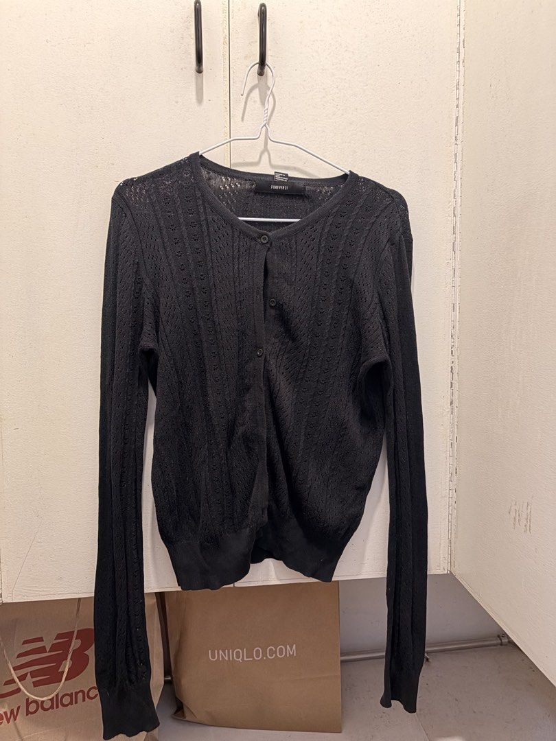 Forever 21 Black Knit Cardigan (Category: Coats, Jackets and Outerwear) located in Pasay City. Submitted by notellyyyy (Listing ID 1465993494, Image 1). Description: - Brand: Forever 21 - Color: Classic Black - Material: Lightweight knit with textured pattern - Fit: Standard fit, neckline sits below the collarbone - Features: Button-down front and long sleeves - Styling: Perfect for easy layering over tops and dresses.