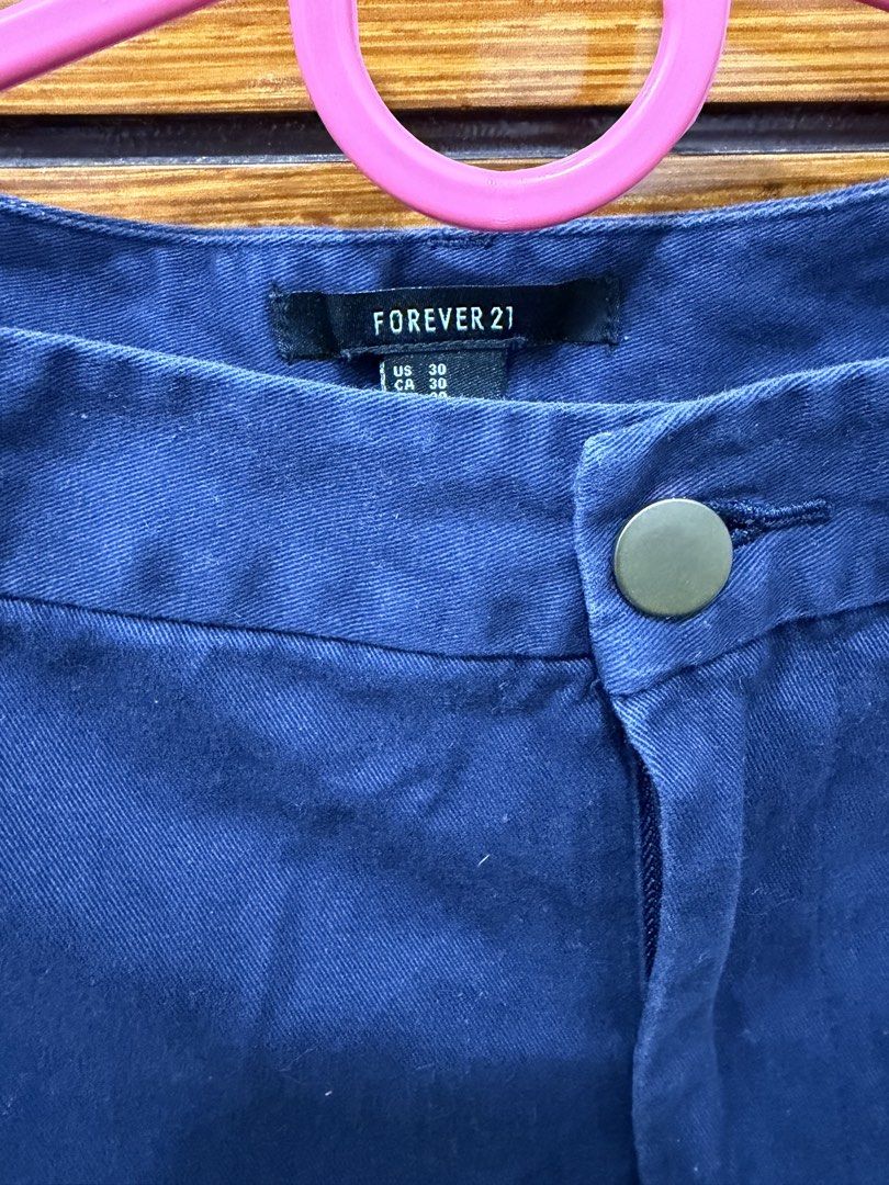Forever 21 Blue Shorts (Category: Shorts) located in Guiguinto. Submitted by twinklingthreads (Listing ID 1466054316, Image 2). Description: - Brand: Forever 21 - Color: Navy Blue - Size: 29 (US/CA) - High-waist - Closure: Front button with zippered fly - Design: Rolled cuffs, solid color - Style: Casual, perfect for warm weather and easy to pair with any top.