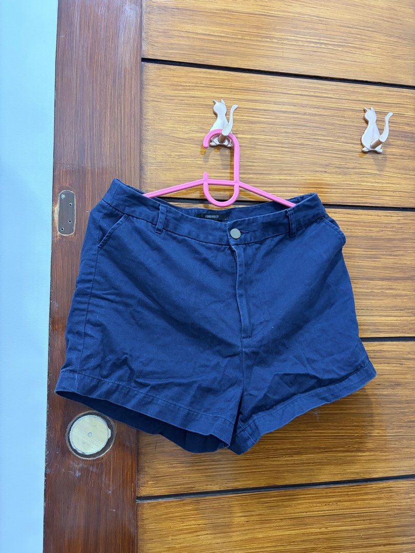 Forever 21 Blue Shorts (Category: Shorts) located in Guiguinto. Submitted by twinklingthreads (Listing ID 1466054316, Image 1). Description: - Brand: Forever 21 - Color: Navy Blue - Size: 29 (US/CA) - High-waist - Closure: Front button with zippered fly - Design: Rolled cuffs, solid color - Style: Casual, perfect for warm weather and easy to pair with any top.