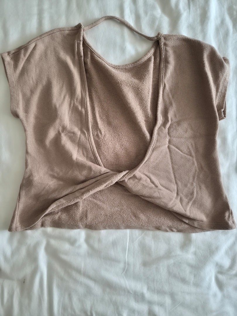 Forever 21 Open Back Twist Hem Top (Category: Sleeveless) located in Quezon City. Submitted by corrnic (Listing ID 1466025660, Image 3). Description: - Brand: Forever 21 - Color: Beige - Size: XS - Material: Soft knit fabric - Design: Short sleeves, crew neckline, deep open back with twist detail and upper strap - Style: Great versatile basic for casual wear or dressing up.