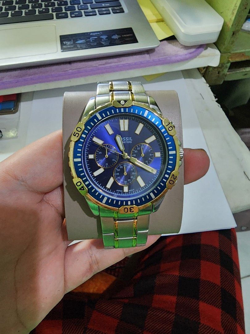 Fossil Blue and Gold Chronograph Watch (Category: Men's Watches) located in Marikina City. Submitted by forkmaster22 (Listing ID 1465987949, Image 1). Description: - Brand: Fossil - Dial: Eye-catching blue with chronograph sub-dials - Strap: Two-tone gold and silver stainless steel bracelet with secure clasp - Bezel: Rotating bezel with 10-minute markers - Movement: Quartz movement with Japanese parts - Style: Striking color combination, great fo