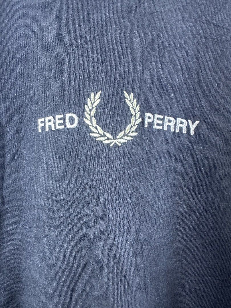 Fred Perry Black Embroidered Logo T-Shirt Medium (Category: Tshirts & Polo Shirts ) located in Manila. Submitted by declutterpromax (Listing ID 1466005636, Image 2). Description: - Brand: Fred Perry - Style: Crew neck t-shirt - Color: Classic Black - Size: Medium (Blue neck tag) - Design: Centered green and white embroidered laurel wreath logo and lettering - Fit: Standard fit, short sleeves - Material: Cotton with normal wear - Flaws: Noticeable