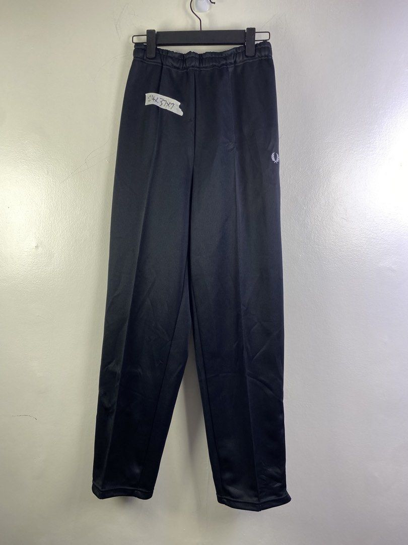 Fred Perry Black Track Pants (Category: Joggers) located in Manila. Submitted by declutterpromax (Listing ID 1466018282, Image 1). Description: - Brand: Fred Perry - Color: Classic Black - Details: Elastic waistband and embroidered laurel wreath logo on the left leg - Condition: Good overall for casual wear or lounging, but please note a small hole near the upper right leg (see close-up photo) - Perfect for: Chill days, errands, and cozy lounging