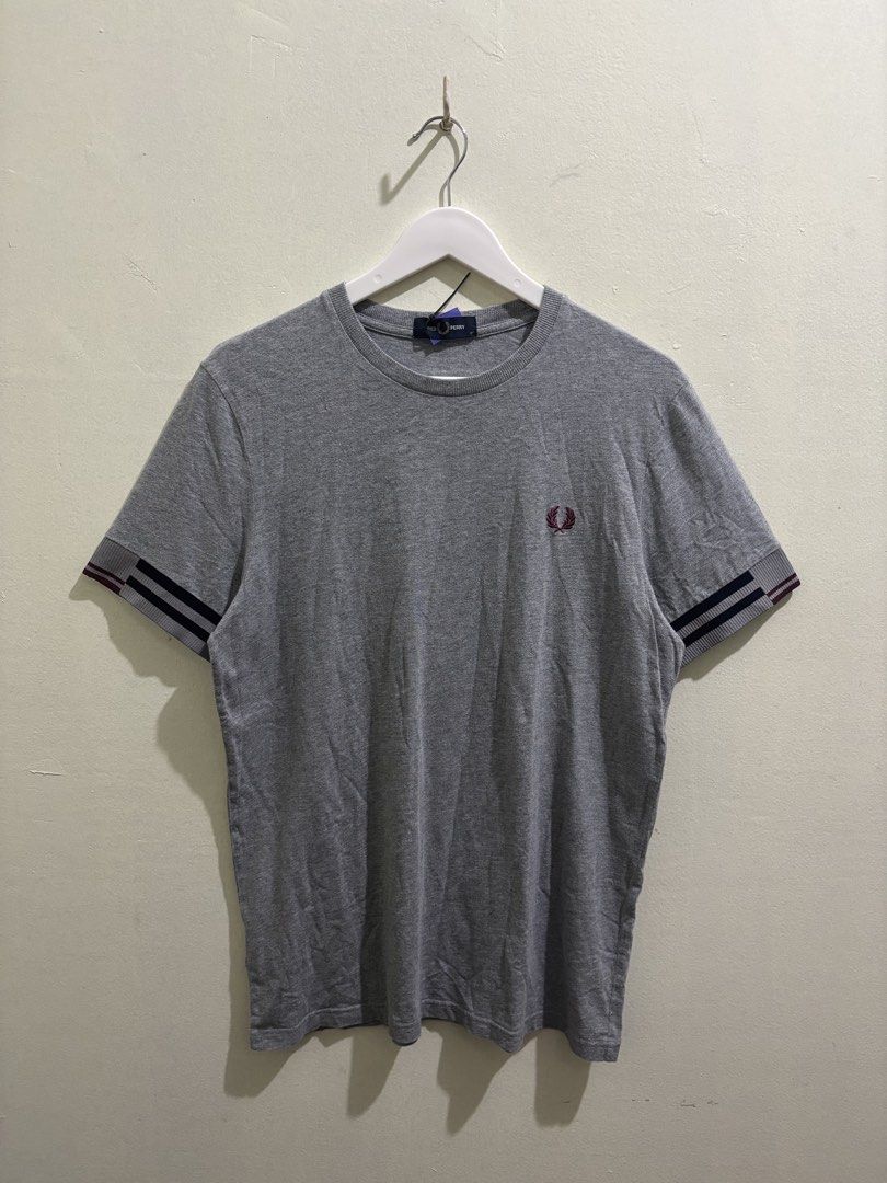 Fred Perry Grey T-Shirt Size M M8529 (Category: Tshirts & Polo Shirts ) located in Daraga. Submitted by hannieldustin (Listing ID 1466063410, Image 1). Description: - Brand: Fred Perry - Style/Model Code: M8529 - Color: Grey - Size: Medium - Condition: Brand new with tags attached - Design Details: Ribbed crew neck, short sleeves with maroon and dark blue striped cuffs, and embroidered laurel wreath logo on the chest - Origin: Made in China - 19.