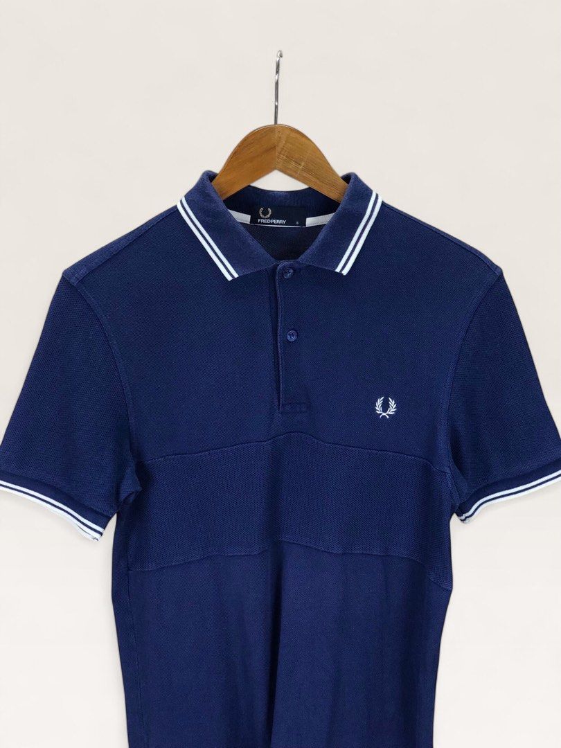 Fred Perry Navy Polo Shirt Size S (Category: Tshirts & Polo Shirts ) located in Manila. Submitted by 12essentials (Listing ID 1466013503, Image 2). Description: 📌 Very Good Condition 📌 S on tag 📌 Length 28’ Width 17’ Authentic navy blue Fred Perry polo shirt in size S. Features the classic white twin tipping, embroidered Laurel Wreath logo, and a stylish contrast textured front panel. PM to order!.