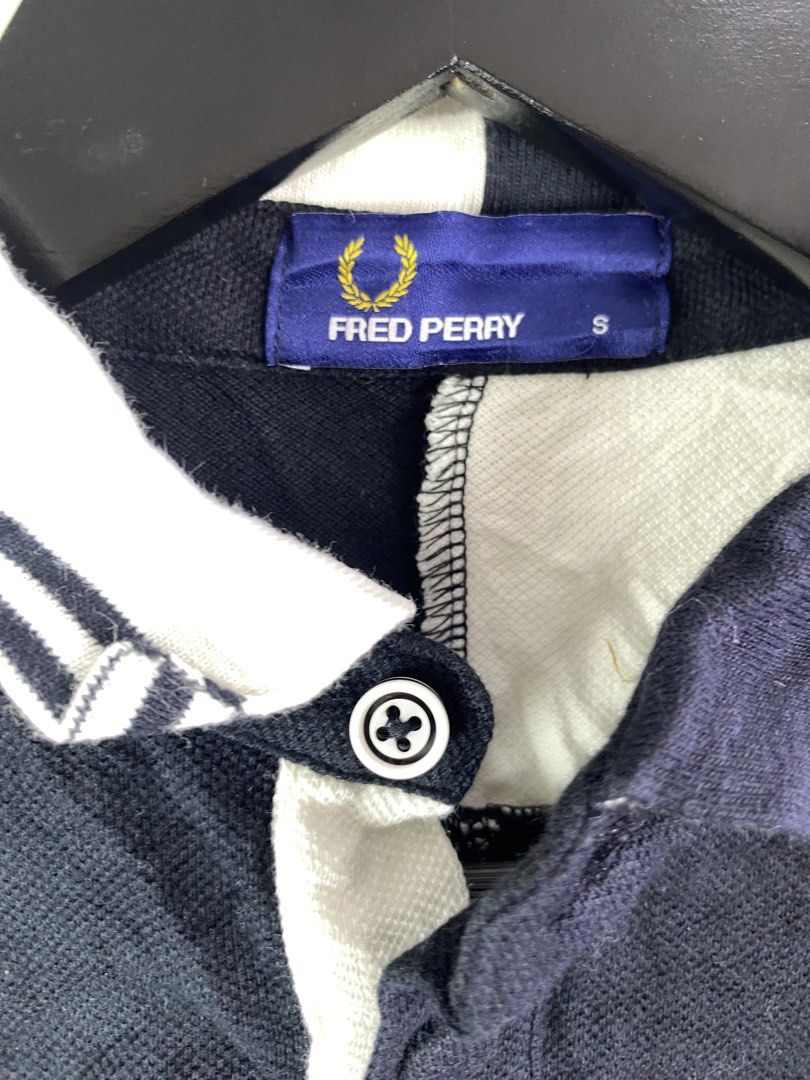 Fred Perry Polo Shirt Size S (Category: Tshirts & Polo Shirts ) located in Manila. Submitted by declutterpromax (Listing ID 1466027580, Image 2). Description: - Brand: Fred Perry (Model F1290, Made in Japan) - Color: Navy blue with contrasting white collar and shoulder panel details - Size: Small (S tag attached) - Material: Soft and breathable cotton pique fabric - Features: Iconic embroidered laurel wreath logo and classic button placket - Cond