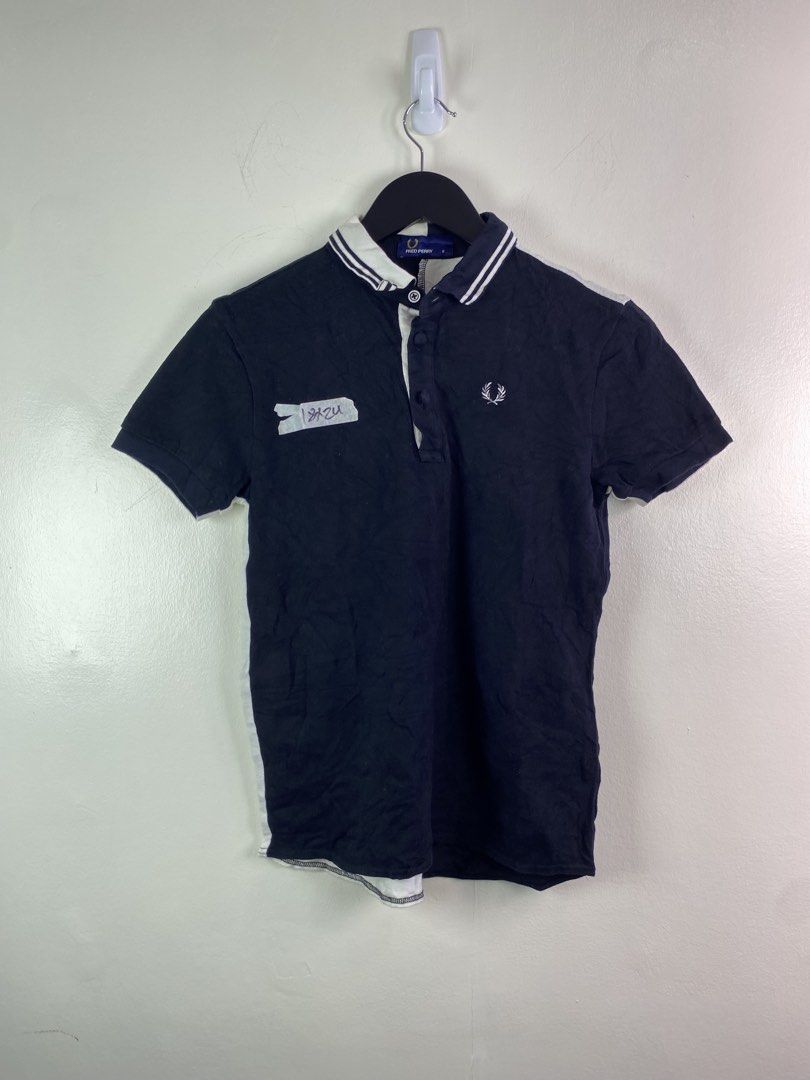 Fred Perry Polo Shirt Size S (Category: Tshirts & Polo Shirts ) located in Manila. Submitted by declutterpromax (Listing ID 1466027580, Image 1). Description: - Brand: Fred Perry (Model F1290, Made in Japan) - Color: Navy blue with contrasting white collar and shoulder panel details - Size: Small (S tag attached) - Material: Soft and breathable cotton pique fabric - Features: Iconic embroidered laurel wreath logo and classic button placket - Cond