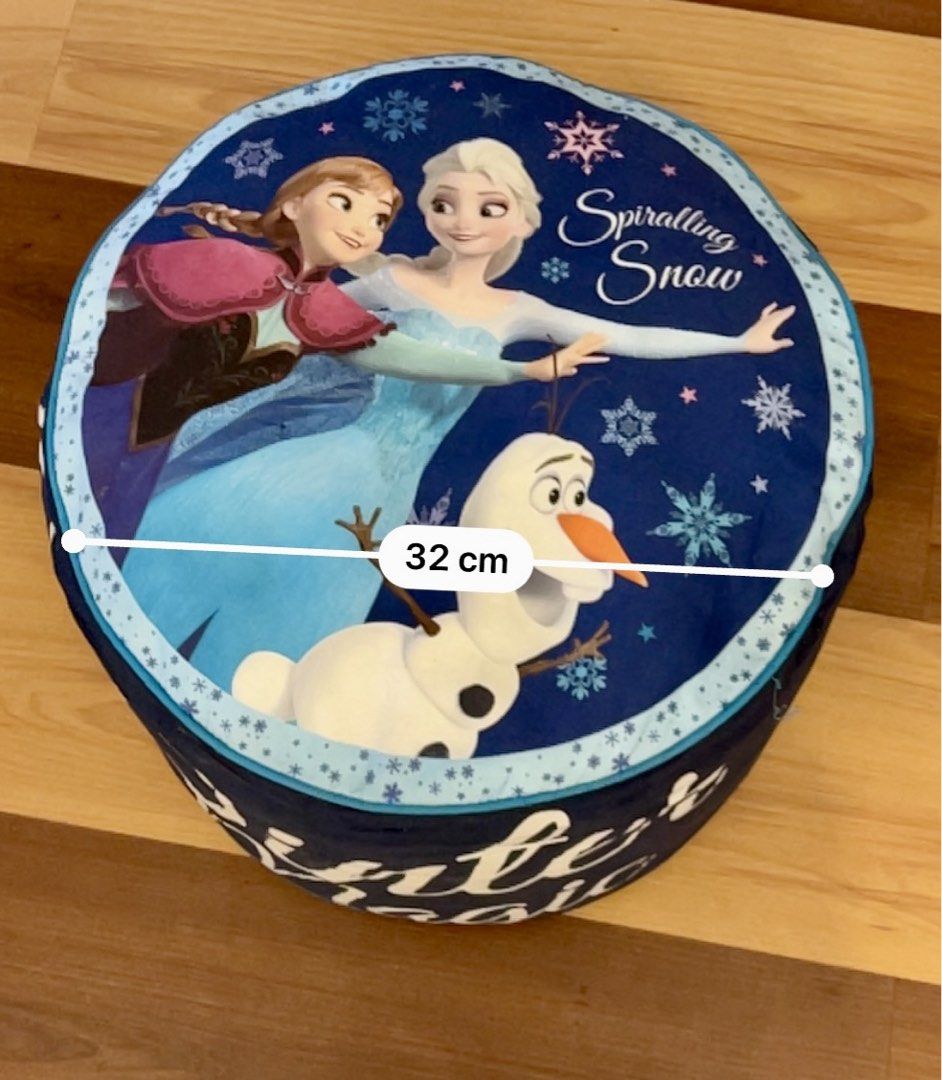 Frozen Elsa Anna Olaf Round Stool (soft) (Category: Chairs) located in Pasig City. Submitted by royalregistry (Listing ID 1465980021, Image 3). Description: - Design: Features Elsa, Anna, and Olaf with a blue snowflake background and 'Winter Magic' text - Dimensions: 32 cm across the top, 21 cm tall - Use: Perfect accent piece for kids' bedrooms or playrooms .