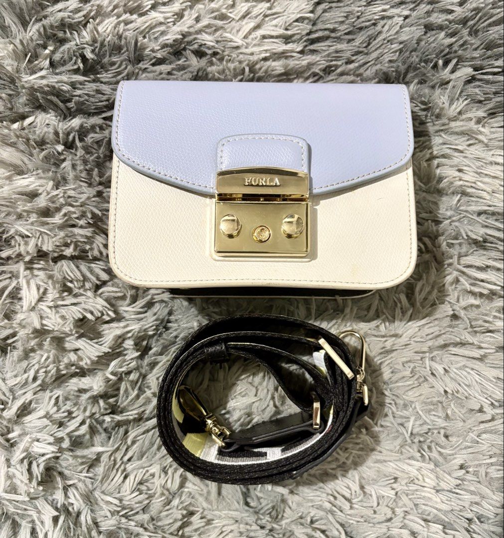 Furla mini bag (Category: Luxury Bags & Wallets) located in Manila. Submitted by jlj_v.2_oshop (Listing ID 1466151019, Image 1). Description: Original Furla Metropolis Brava Mini Crossbody Bag in a colorblock design with a light blue flap, white body, and gold-tone metal lock.