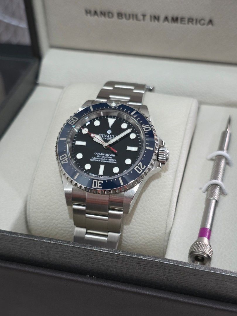 Ginault Ocean Rover (Category: Men's Watches) located in Antipolo. Submitted by giancookie (Listing ID 1465969638, Image 2). Description: - Brand/Model: Ginault Ocean Rover - Design: Classic black dial paired with a striking blue ceramic bezel insert - Build: Durable stainless steel case and matching bracelet - Movement: Reliable Swiss mechanical movement - Inclusion: Complete with original presentation box, adjustment tool, and authenticity pape