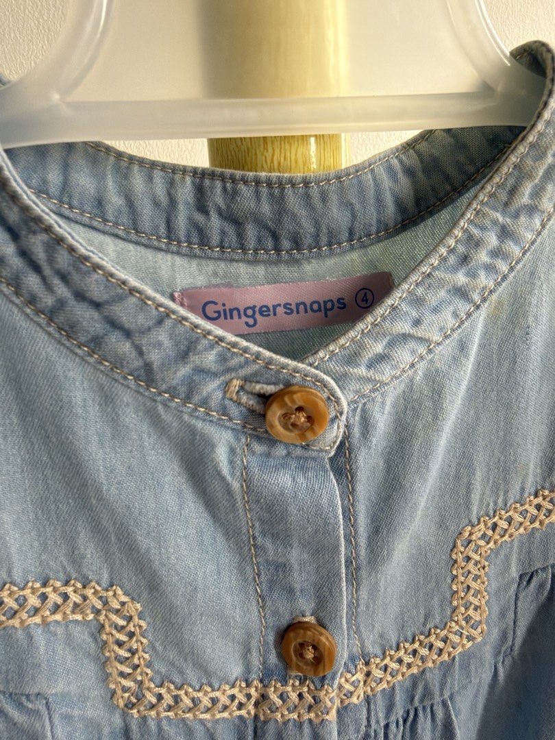 Gingersnaps Denim Jumpsuit Size 4 (Category: Babies & Kids Fashion) located in Quezon City. Submitted by warmrabbit_414908 (Listing ID 1465985995, Image 2). Description: - Brand: Gingersnaps - Size: 4 years - Color: Light blue - Material: Lightweight chambray - Design: Short puff sleeves with ruffled shoulders and chest embroidery - Features: Front button closure with wooden-look buttons, elastic waistband, side pockets, and elastic ankle cuffs -