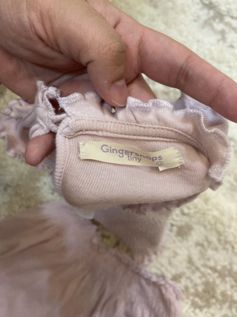 Gingersnaps Tiny Light Purple Smocked Top and Skirt Set (Category: Babies & Kids Fashion) located in Bulacan. Submitted by aksantos10 (Listing ID 1466073103, Image 3). Description: - Brand: Gingersnaps (Tiny Collection) - Size: 12 - Color: Light purple - Material: Soft, stretchy cotton - Top: Sleeveless with smocked fabric, ruffled shoulders, and a back keyhole with button closure - Skirt: Comfortable elastic waistband with matching ruffle trim -