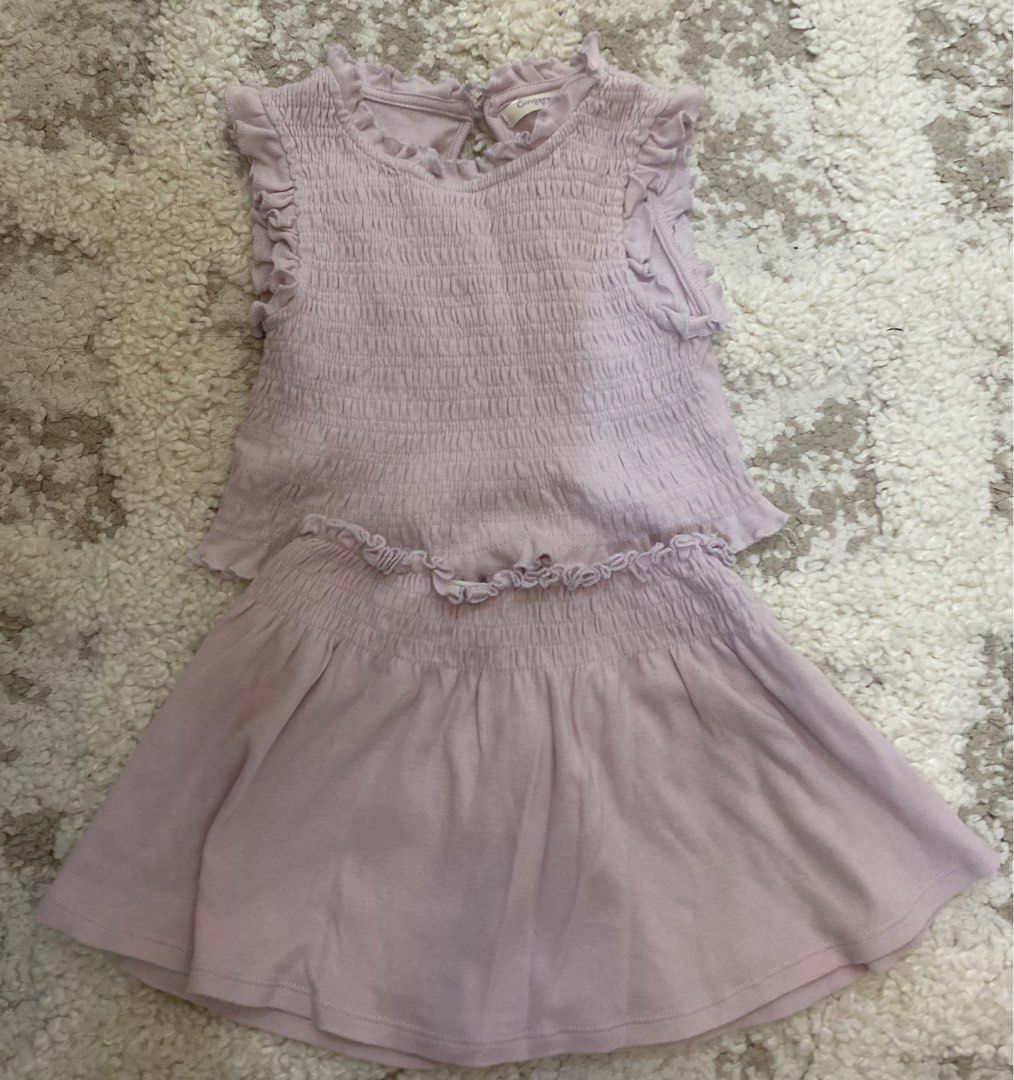 Gingersnaps Tiny Light Purple Smocked Top and Skirt Set (Category: Babies & Kids Fashion) located in Bulacan. Submitted by aksantos10 (Listing ID 1466073103, Image 1). Description: - Brand: Gingersnaps (Tiny Collection) - Size: 12 - Color: Light purple - Material: Soft, stretchy cotton - Top: Sleeveless with smocked fabric, ruffled shoulders, and a back keyhole with button closure - Skirt: Comfortable elastic waistband with matching ruffle trim -