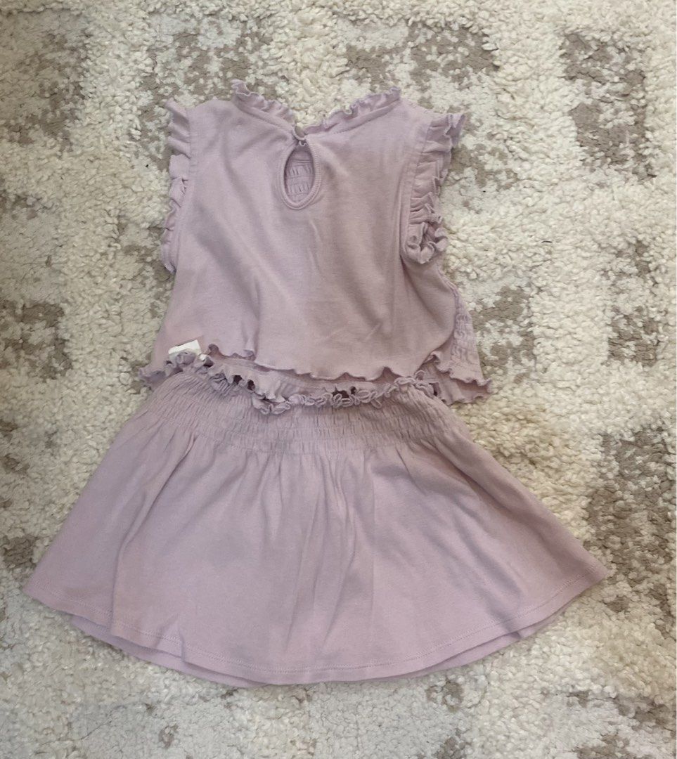 Gingersnaps Tiny Light Purple Smocked Top and Skirt Set (Category: Babies & Kids Fashion) located in Bulacan. Submitted by aksantos10 (Listing ID 1466073103, Image 2). Description: - Brand: Gingersnaps (Tiny Collection) - Size: 12 - Color: Light purple - Material: Soft, stretchy cotton - Top: Sleeveless with smocked fabric, ruffled shoulders, and a back keyhole with button closure - Skirt: Comfortable elastic waistband with matching ruffle trim -