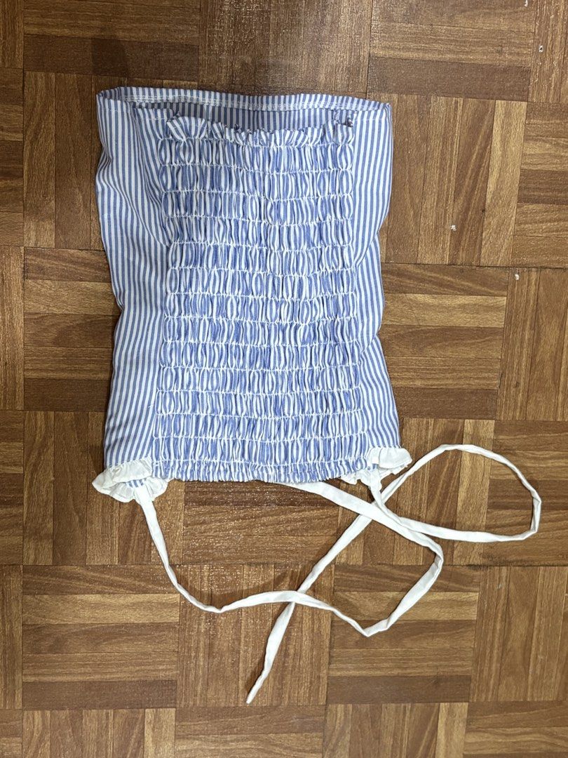 Girl Code Blue and White Striped Halter Top (Category: Sleeveless) located in Manila. Submitted by nykji96 (Listing ID 1465965244, Image 2). Description: - Brand: Girl Code - Size: Small - Design: Blue and white vertical stripes with white neck ties and front bow - Details: Sweetheart neckline with ruffle trim - Fit: Full smocked back for extra stretch and comfort - Material: Cotton blend - Condition: Brand new / Excellent.