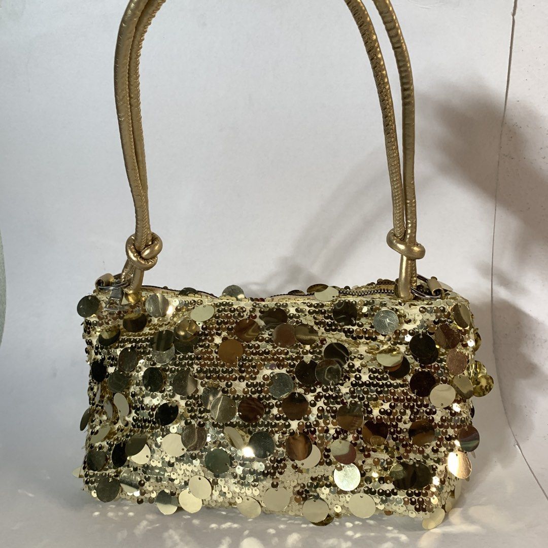 Gold sequin shoulder bag sparkly evening purse (Category: Purses & Pouches) located in Rizal. Submitted by shop_ms.lai (Listing ID 1465953870, Image 2). Description: - Color: Shiny Gold - Material: Fully covered in eye-catching sequins - Straps: Double gold straps with stylish knotted details - Closure: Top zipper to keep your essentials secure - Size: Small rectangular shape, ideal for parties and night outs - Condition: Brand new / Excellent (r