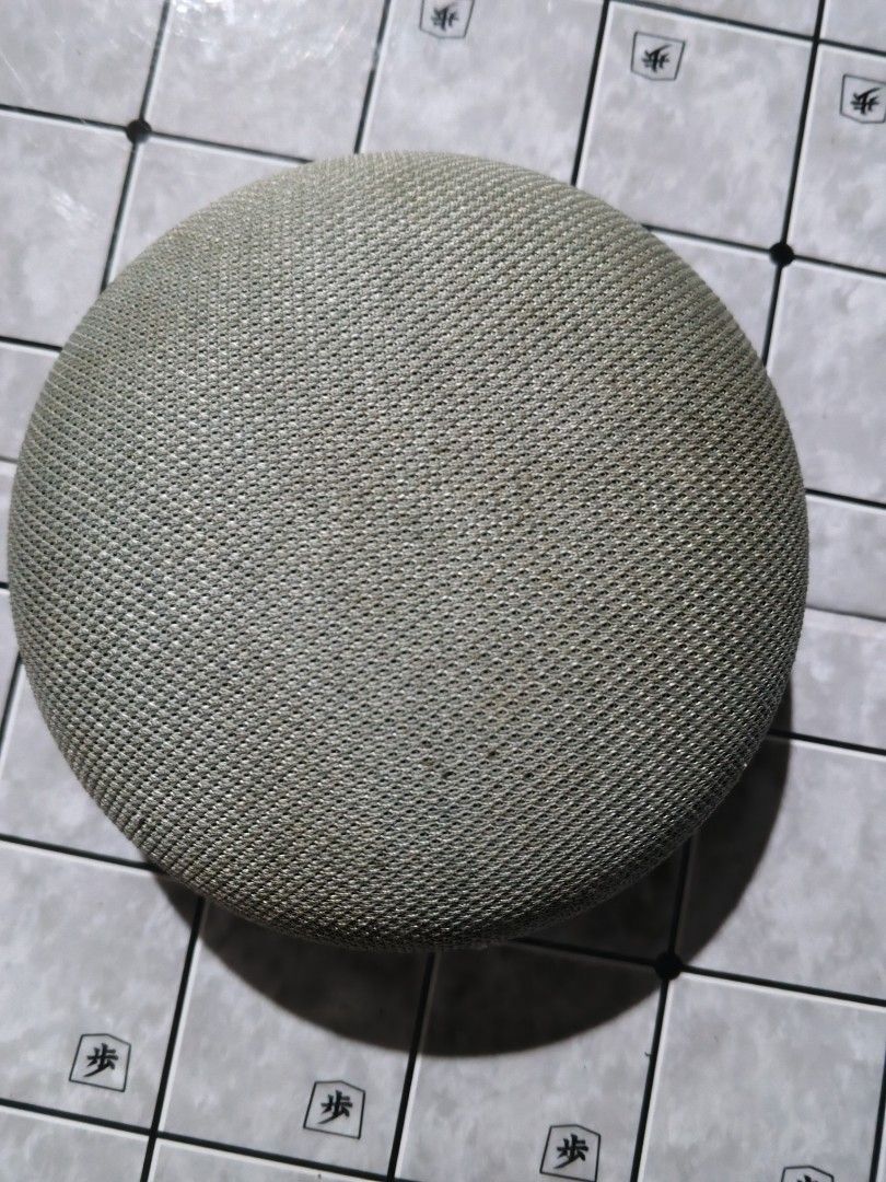 Google Home Mini Smart Speaker (Category: Soundbars, Speakers & Amplifiers) located in San Jose del Monte. Submitted by toys.merch.electronic (Listing ID 1466104173, Image 1). Description: - Authentic Google Home Mini in Sage Green fabric mesh - Orange rubber base with Google logo - Tested and fully working (powers on with 4 indicator lights) - Compact size, perfect for voice control and casual music streaming - Flaw: Small dark mark on the side 