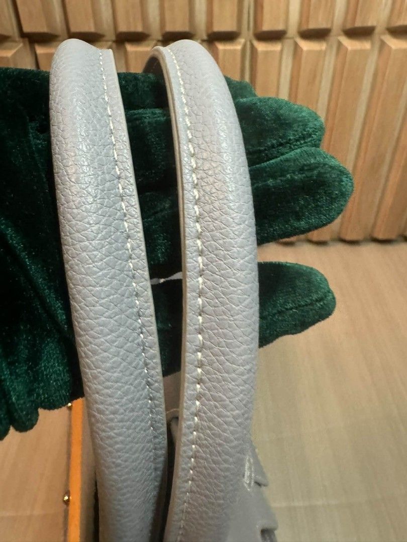 Goyard Saumur Grey Tote Bag (Category: Luxury Bags & Wallets) located in Manila. Submitted by goodbuying_items0211 (Listing ID 1466124255, Image 3). Description: Grey leather tote with Goyard monogram canvas panels. Wooden accent bar across the back. Structured top handle design with a front flap closure and buckle strap. Clean stitching throughout. Sturdy grey handles and reinforced corner patches..