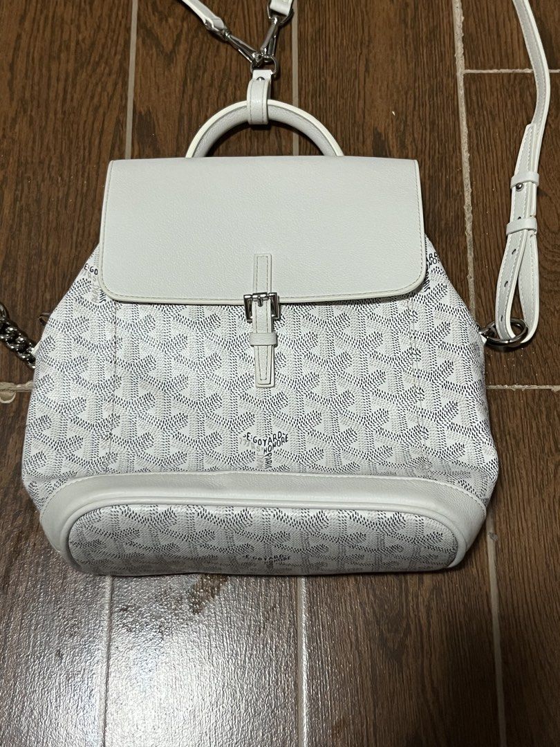 Goyard White Belvedere Backpack Purse (Category: Luxury Bags & Wallets) located in Victorias. Submitted by lan1877 (Listing ID 1466052118, Image 1). Description: White Goyard backpack with classic chevron canvas pattern. Structured flap top with buckle strap closure, top handle, and adjustable shoulder straps. Interior lined in light canvas with stamped Goyard Paris Made in France logo and serial number MAE020194. Hardware features engraved Goyar