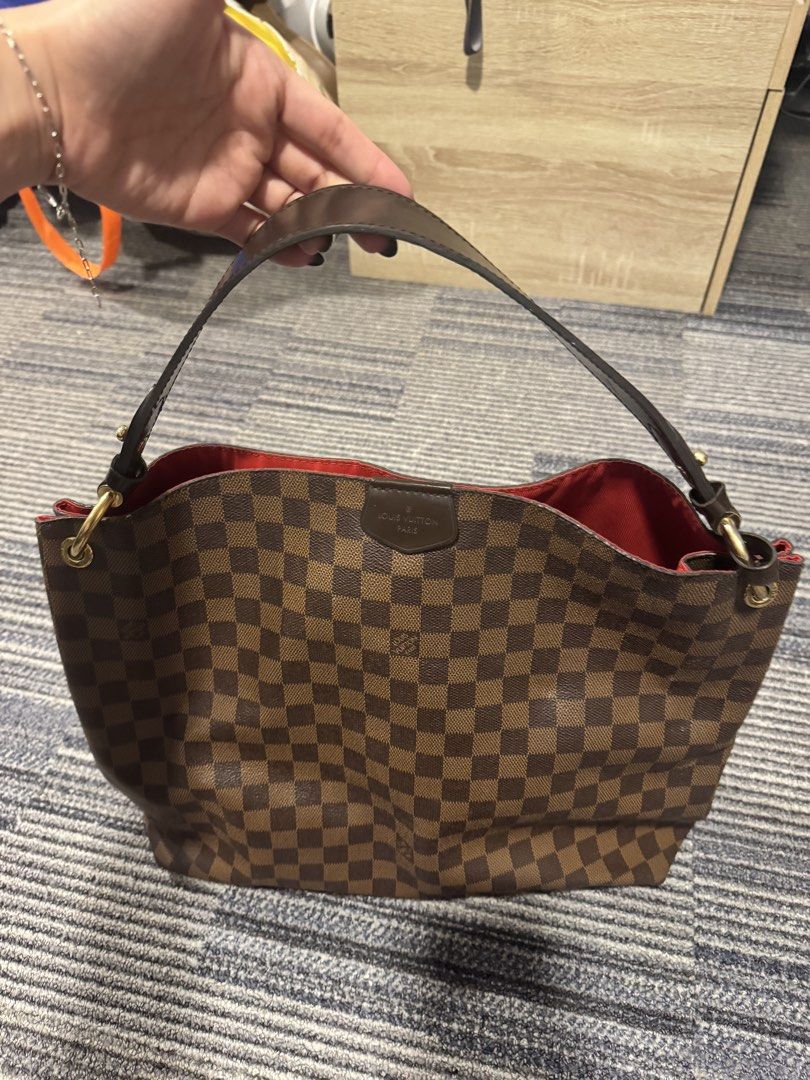 graceful Louis Vuitton Damier Ebene Berkeley Handbag (Category: Luxury Bags & Wallets) located in Calamba. Submitted by im.fineee (Listing ID 1465974763, Image 2). Description: - Brand: Louis Vuitton - Style: Classic hobo shoulder bag - Material: Damier Ebene canvas with dark brown leather trim - Hardware: Gold-tone - Interior: Spacious red lining - Details: Front leather patch stamped with Louis Vuitton Paris - Condition: Excellent daily use bag